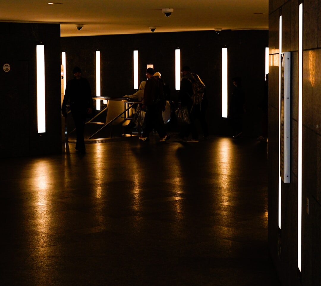 Guests arriving in formal wear at a grand theater entrance at night