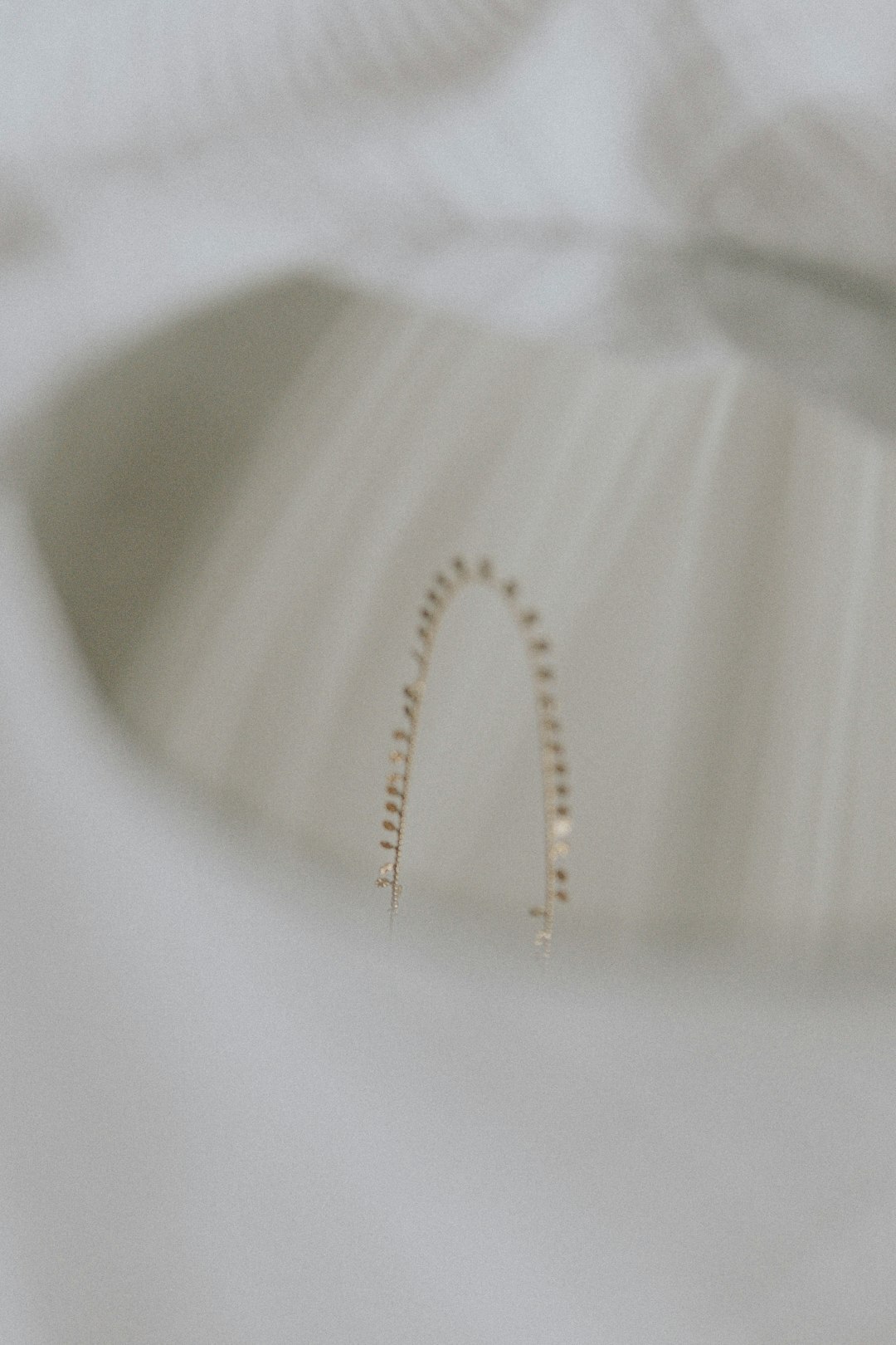 Close up of gold jewelry and silk fabric texture