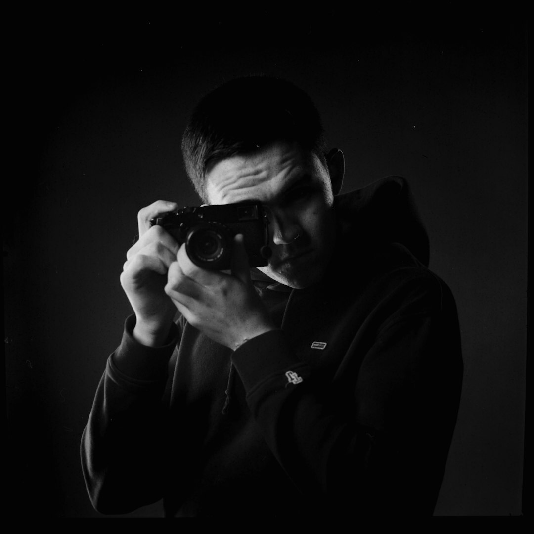 Photographer adjusting a camera backstage before a show